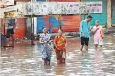  ?? Reuters & PTI ?? Heavy rains hit Ahmedabad and Gandhinaga­r over the weekend, disrupting traffic and flooding homes. Reports said dozens of train services were cancelled, while more than 50,000 were evacuated as officials moved to prevent deaths or injury due to the deluge.