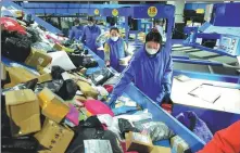  ?? ZHANG ZHENGYOU / FOR CHINA DAILY ?? Middle: Workers sort parcels on a belt in a logistics park in Donghai county, Jiangsu province, on Nov 11.