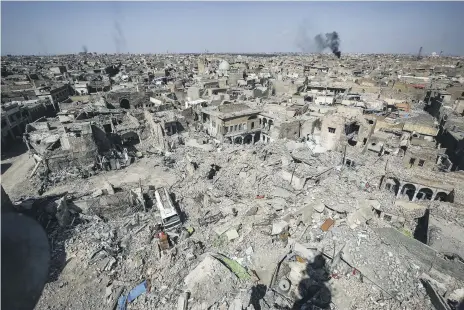  ??  ?? In Mosul today, the victims of ISIS’s rule are still being dug out from under the rubble of the city’s ruined streets