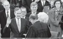  ?? Carlos Schiebeck / AFP/Getty Images ?? President George H.W. Bush, with wife Barbara, takes the oath of office on Jan. 20, 1989, from Chief Justice William Rehnquist.