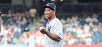  ?? ASSOCIATED PRESS ?? New York Giants rookie running back Saquon Barkley throws out the first pitch at a Yankees game last month.