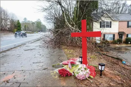  ?? JASON GETZ/ JASON.GETZ@AJC.COM ?? An impromptu memorial marks the spot where University of Georgia football player Devin Willock and UGA staff member Chandler LeCroy died after a high-speed, alcohol-fueled crash in a street race with another UGA player in Athens on Jan. 15, 2023.