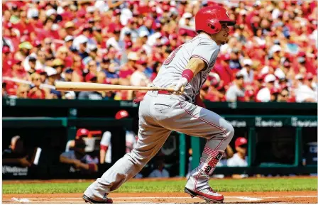  ?? DILIP VISHWANAT / GETTY IMAGES ?? Cincinnati second baseman Scooter Gennett smacks an RBI double in the first inning against the Cardinals at Busch Stadium in St. Louis. Gennett had two hits in Sunday’s game to push his league-leading batting average to .319.