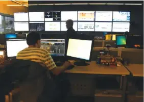  ?? STAFF FILE PHOTO BY TIM BARBER ?? Two men operate the EPB fiber optic control room where the city-owned utility operates its 10-GB broadband service across the Chattanoog­a region.