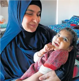  ?? Photo / Getty Images ?? Alisha Shaikh, 3, is held by playgroup co-ordinator Aminah Khaled. Alisha’s mother, Rizwana Shaikh, died of cancer on Sunday.