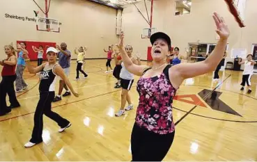  ??  ?? Beth Nunez leads a Zumba class at the Sheinberg Family YMCA of Weston, Florida.