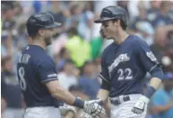  ?? AP ?? Christian Yelich (right) celebrates with Ryan Braun after hitting his 34th home run, which tied the MLB lead.