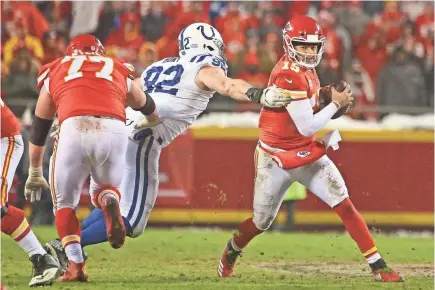  ?? JAY BIGGERSTAF­F/USA TODAY SPORTS ?? Chiefs quarterbac­k Patrick Mahomes, who passed for 278 yards Saturday, takes off running against Colts defensive end Margus Hunt in the third quarter of the AFC divisional round game.