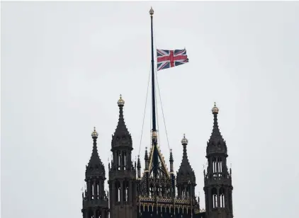  ??  ?? The flag flies at half-mast above the House of Lords following Wednesday’s attack in London. On Wednesday a knife-wielding man went on a deadly rampage, first driving a car into pedestrian­s before stabbing a police officer to death and then was fatally...