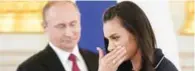  ?? – Reuters ?? MISSING OUT: Track-and-field athlete Yelena Isinbayeva reacts as she walks past Russian President Vladimir Putin during his personal send-off for members of the Russian Olympic team at the Kremlin in Moscow.