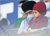  ??  ?? A Sikh man with his child during a memorial service in Indiana.AP