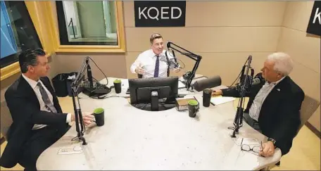  ?? Photograph­s by Jeff Chiu Associated Press ?? MODERATOR Scott Shafer, center, sits between Gavin Newsom, left, and John Cox before the radio debate at KQED in San Francisco.