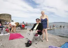  ??  ?? SUN SEEKERS: Fr Austin Healy with his sister Mary Moore