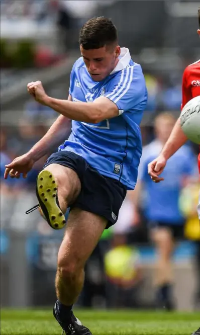  ??  ?? Ross McGarry of Dublin kicks a point under pressure fron Eoghan Callaghan.