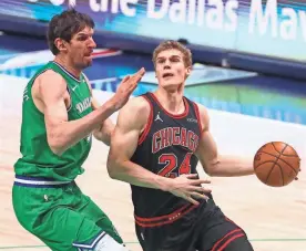  ?? KEVIN JAIRAJ/USA TODAY SPORTS ?? Bulls forward Lauri Markkanen (24) drives to the basket as Mavericks center Boban Marjanovic (51) defends during the first half.