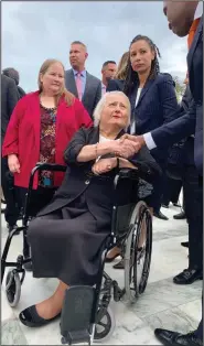  ?? (The Detroit News/TNS/Melissa Nann Burke) ?? Michigan’s Aimee Stephens, flanked by wife Donna at left and ACLU attorney Ria Tabacco Mar, greets well-wishers outside the U.S. Supreme Court in 2019 after the justices heard arguments in her case. Five weeks after Aimee Stephens’ death from kidney disease, the Supreme Court ruled in her favor.