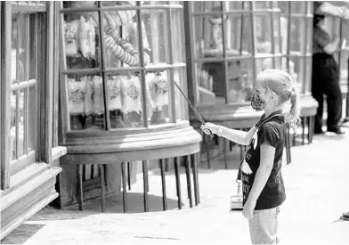  ?? PATRICK CONNOLLY/ORLANDO SENTINEL ?? A young visitor enjoys The Wizarding World of Harry Potter in Universal’s Islands of Adventure during its official reopening June 5.