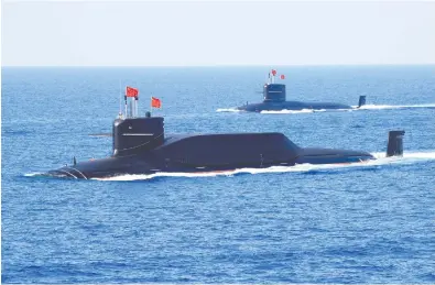  ?? REUTERS/STRINGER ?? Above is China's Type 094A Jin-class ballistic missile submarine. China's next generation of nuclear submarines —
and an advanced new missile they are expected to carry — would be able to target the U.S. from China's shores.