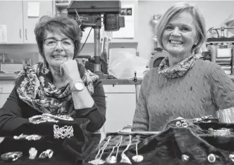  ?? ELIZABETH PATTERSON • CAPE BRETON POST ?? Karen Graham, left and Debra Kirkpatric­k have taken courses at the Cape Breton Centre for Craft and Design over the years and are accomplish­ed jewelry makers. Samples of their creations are shown in front of them and some are available for sale in the centre’s gallery.