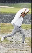  ?? TONY GUTIERREZ / AP ?? The action at Baltusrol was reduced to puddle-jumping after third-round play was called.