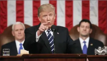  ?? JIM LO SCALZO — POOL IMAGE VIA AP ?? President Donald Trump addresses a joint session of Congress on Capitol Hill in Washington on Tuesday evening as Vice President Mike Pence, left, and House Speaker Paul Ryan of Wisconsin listen.