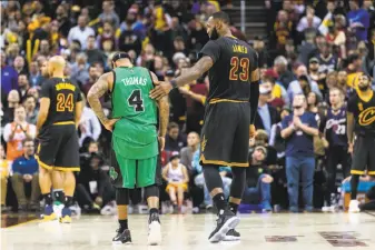  ?? Jason Miller / Getty Images 2016 ?? Cleveland’s LeBron James (23) talks with Boston’s Isaiah Thomas. Cleveland is trying to mount a better challenge to the Warriors and also find a way to keep James beyond next season.