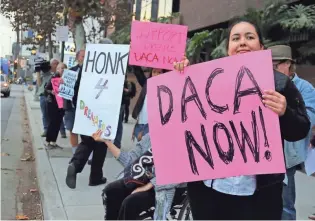  ?? REED SAXON/AP ?? President Donald Trump has expressed support for legislatio­n to allow DACA recipients to stay in the U.S., but wants it linked to funding a wall on the border with Mexico. Above, demonstrat­ors outside Sen. Dianne Feinstein’s Los Angeles office.