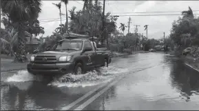  ?? JOEY FLECHAS/MIAMI HERALD ?? King tide brought high waters that flooded several low-lying streets on Normandy Isle in North Beach in Miami on Oct. 5, 2017.