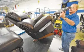  ?? STAFF FILE PHOTO BY TIM BARBER ?? Rick Johnson, quality technician, inspects operation of a recliner before moving it to shipping in the standard La-Z-Boy recliner cellular team section of Plant 6 at the Dayton facility.