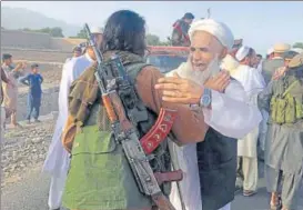 ?? AP FILE ?? ▪ Taliban fighters celebrate the Eid ceasefire with residents of Nangarhar province on June 16.