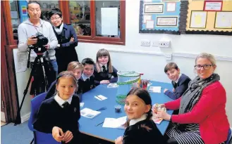  ??  ?? Prestbury CE Primary School teacher Hannah Hague with pupils Natasha Oldham, Bruno Smith-Lomas, Tom Hargreaves, George Ackerley, Hannah Routley and Lydia Ellmore, plus the crew from China TV