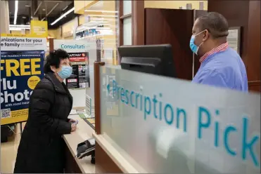  ?? Photo for The Washington Post by Amanda Andrade-Rhoades ?? Ramona Cohen, 75, speaks to an employee at a Safeway grocery store pharmacy in Washington, D.C. on Jan. 15, 2021.