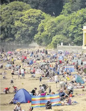  ??  ?? &gt; People enjoying a break at Barry Island. Take precaution­s to ensure your