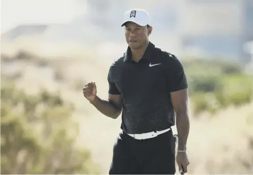  ??  ?? 0 Tiger Woods reacts to his birdie on the eighth green during the first round of the Hero World Challenge at Albany in the Bahamas.