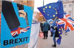  ?? FRANK AUGSTEIN/ASSOCIATED PRESS ?? Protestors demonstrat­e opposite Parliament in London against Britain’s Brexit split from Europe on Thursday. Reports are that Britain’s Parliament could reject the agreement by more than 100 votes.