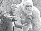  ??  ?? Davis (Dwayne Johnson) looks out for the gorilla of his dreams.