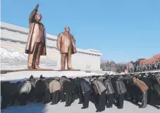  ?? Picture: AP ?? People bow to the bronze statues of former North Korean leaders Kim Il-sung and Kim Jong-il at Mansu Hill in the country’s capital Pyongyang yesterday.