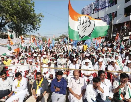  ?? — REUTERS ?? A supporter of Rahul Gandhi, a senior leader of India’s main opposition Congress party, waves a party flag in a public meeting during Rahul’s 66-day long “Bharat Jodo Nyay Yatra”, or Unite India Justice March in Jhalod town, Gujarat state, on March 7, 2024.