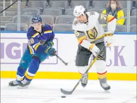  ??  ?? Golden Knights right wing Ryan Reaves controls the puck ahead of Blues center Robert Thomas during the second period of St. Louis’ 3-1 win Wednesday.