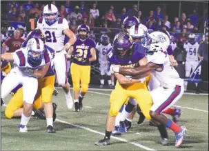  ?? The Sentinel-Record/Grace Brown ?? ASKING A LOT: Fountain Lake senior running back Joe Murphy (20) is tackled by Arkadelphi­a senior linebacker Zion Hatley (24) Friday night at Fountain Lake’s Allen Tillery Field. Murphy led the Cobras’ offense with 16 carries for 88 yards.