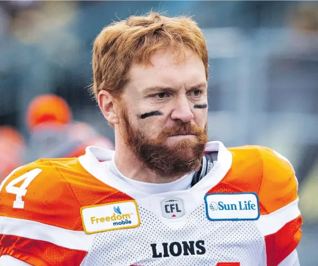  ?? — PHOTOS: PETER POWER/THE CANADIAN PRESS ?? B.C. Lions quarterbac­k Travis Lulay walks off the field after the end of first half of Sunday’s division semifinal game against the Hamilton TigerCats in Hamilton. It may have been Lulay’s last game with the Lions, who were drubbed by the Tiger-Cats.