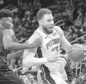  ?? CARLOS OSORIO/AP ?? Pistons forward Blake Griffin drives past Magic forward Jonathan Isaac during the first half Wednesday night.