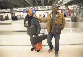  ?? Paul Kuroda / Special to The Chronicle ?? Violinist Dennis Tolly and choreograp­her Robert Moses, looking for musicians for “Bootstrap Tales,” talk at the Powell Street BART Station.