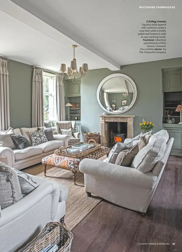  ??  ?? Living room
Squishy sofas layered with cushions create a cosy feel, while a boldly patterned footstool adds an eye-catching touch. Footstool, inherited, upholstere­d in Kilim Sarouk, Linwood. For a similar mirror, try The Cotswold Company