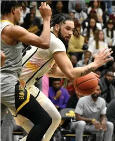  ?? Bluff Commercial/I.C. Murrell) (Pine ?? Chris Greene of UAPB pivots for a shot against Alabama State defenders on Feb. 11.