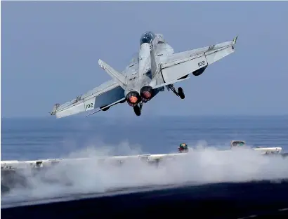  ?? USS Dwight D. Eisenhower AP ?? A US navy fighter jet takes off from the deck of the aircraft carrier. The carrier is currently deployed in the Arabian Gulf, supporting the military operation against Daesh in Syria and Iraq. —