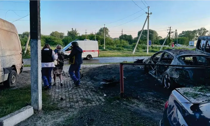  ?? Photograph: Governor of Belgorod region/Handout/EPA ?? A survivor is led away from the wreckage after shelling in Shebekino, in Russia's Belgorod province.