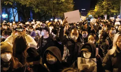  ?? ?? A vigil in Beijing for victims of a fire in Urumqi. Photograph: Thomas Peter/Reuters