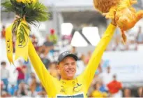  ?? THE ASSOCIATED PRESS ?? Chris Froome celebrates after winning the Tour de France on Sunday.