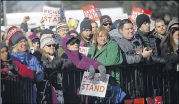  ?? RACHEL WOOLF / GETTY IMAGES ?? People opposed to repeal of the Affordable Health Care act listen to a speaker during a rally in the Detroit suburb of Warren, Mich. The event was one of more than 40 such rallies that took place around the country Sunday.